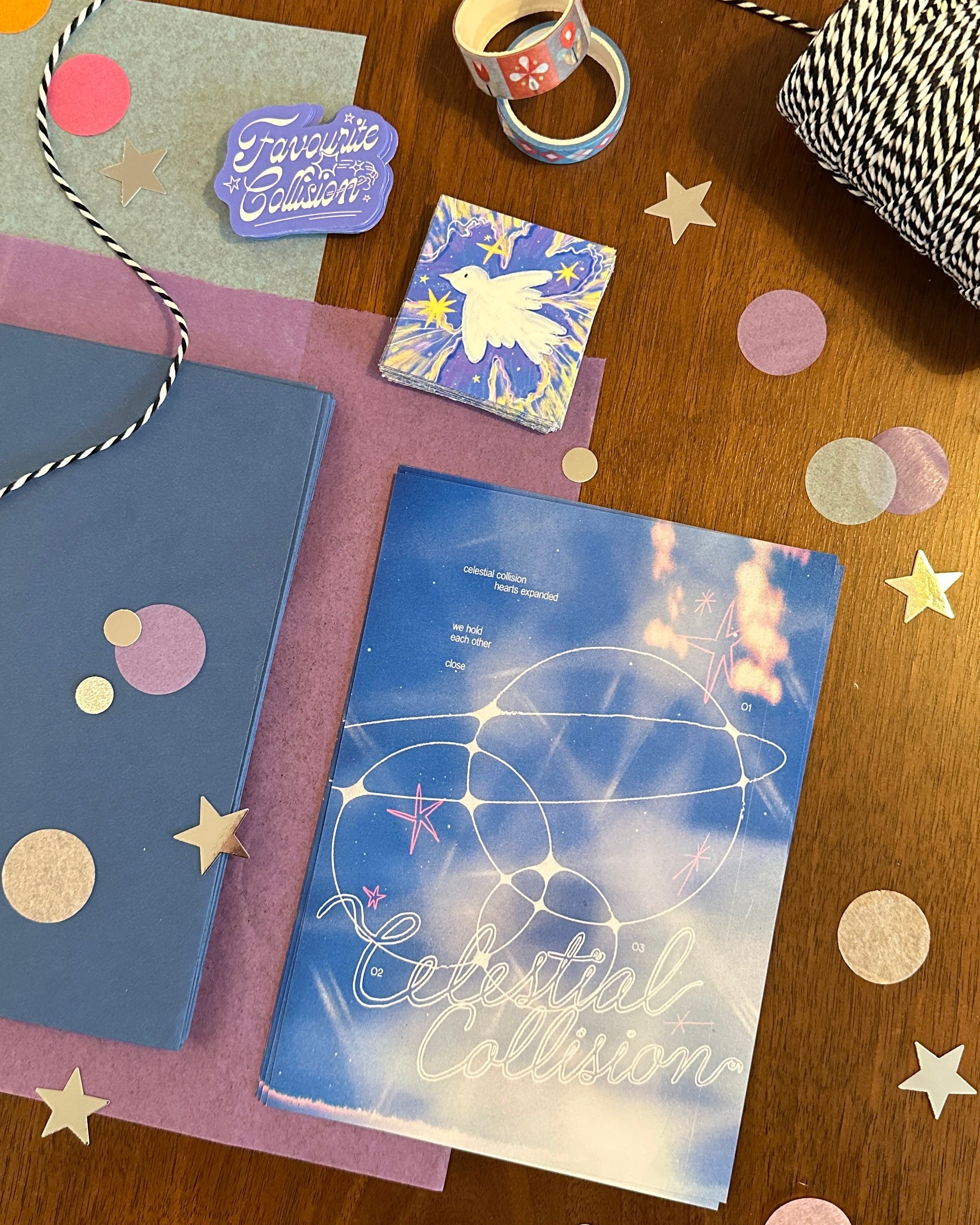 Notebooks, a mug, and decorative items on a wooden surface with confetti.